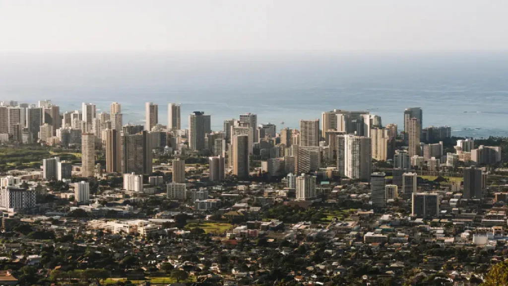 This image shows a skyline of Honolulu with tall buildings near the ocean, possibly a location for a mesothelioma lawyer.