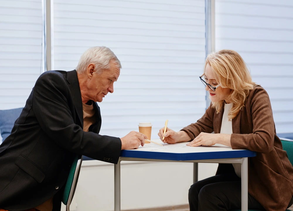 old man consulting to a lawyer for a mesothelioma case