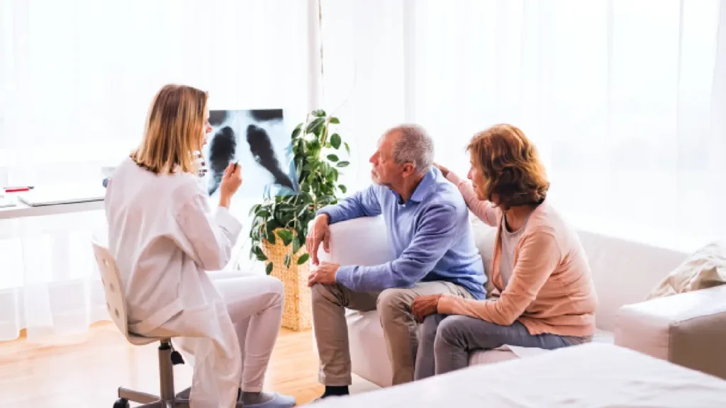 doctor explaining a lung X-ray to a concerned couple