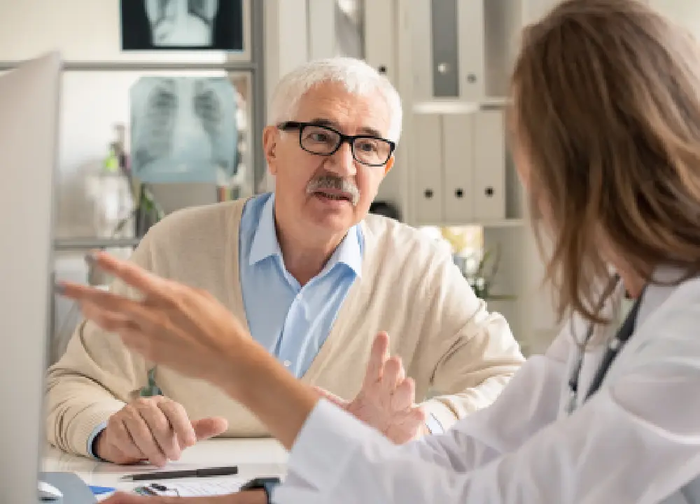 Elderly man consulting a doctor for medical advice and support