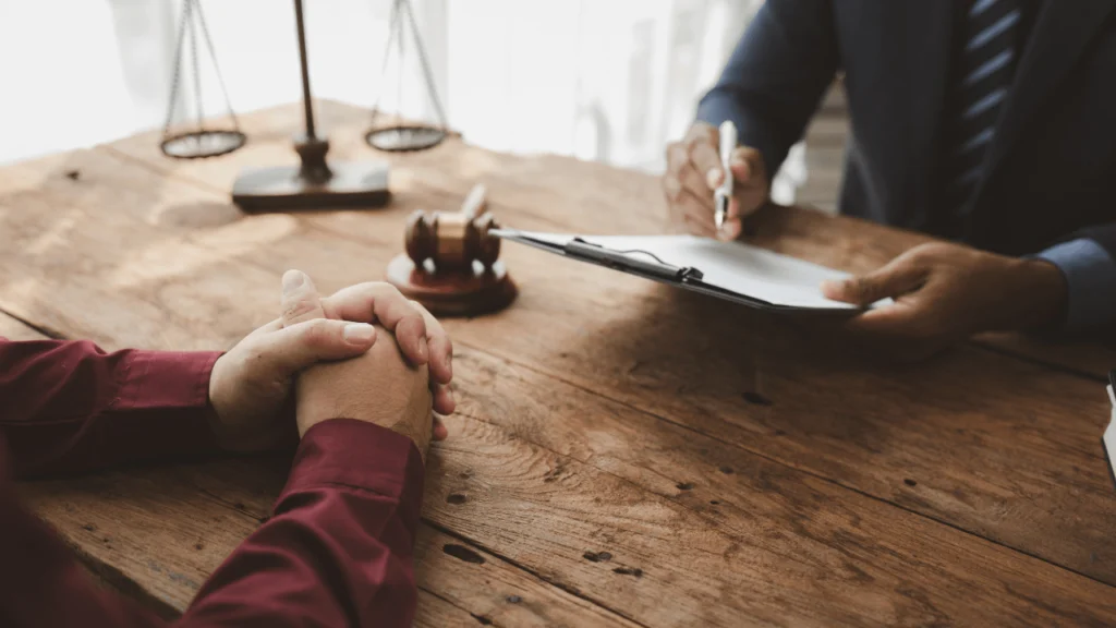 compassionate attorney meeting with a mesothelioma patient and their family at a legal office.