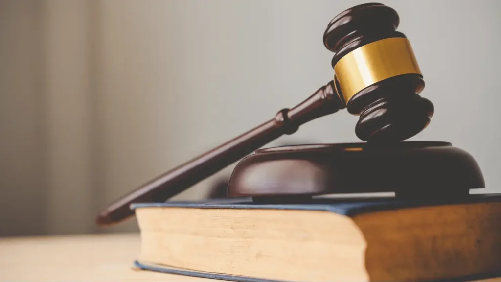 Judge’s gavel and law book symbolizing legal cases related to the Largest Asbestos Settlements.