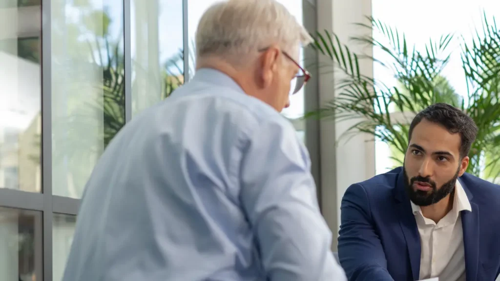 Lawyer explaining documents or claims to a veteran, highlighting legal options after asbestos exposure.